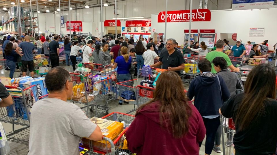 People-line-up-in-supermarket-to-buy-stuff